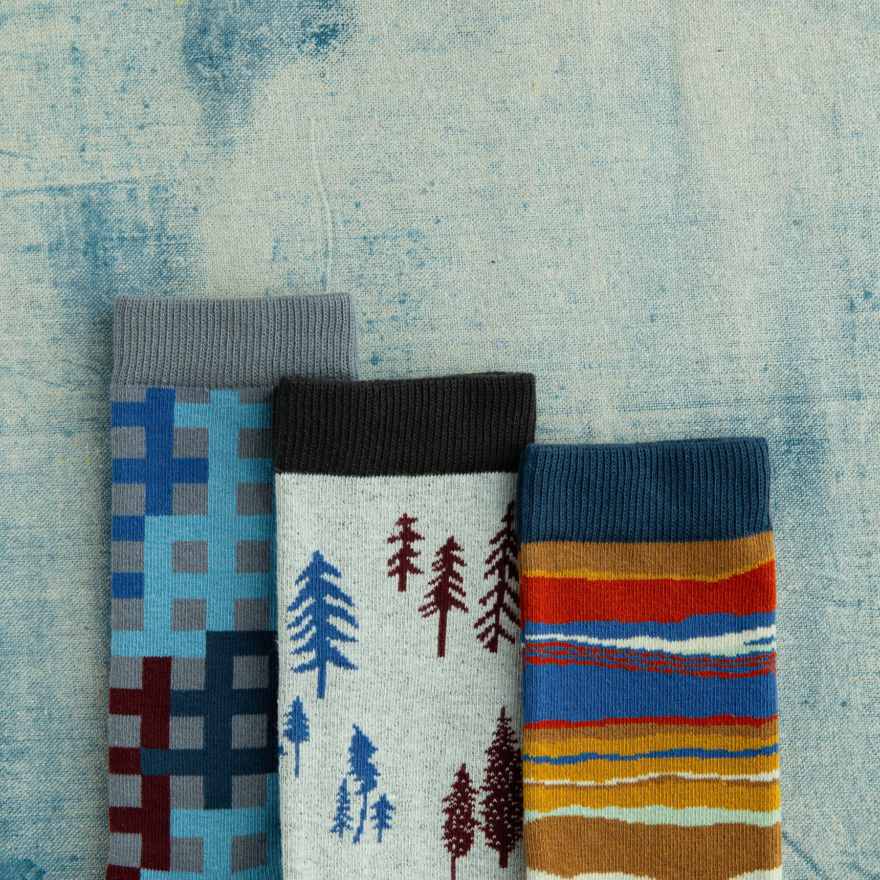 men's patterned organic cotton socks on a painted surface