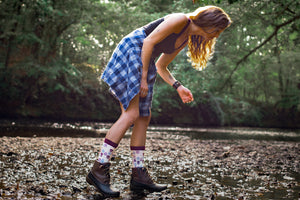 woman standing on a river bank wearing flower patterned organic cotton socks