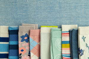 brightly colored organic cotton socks on a blue surface