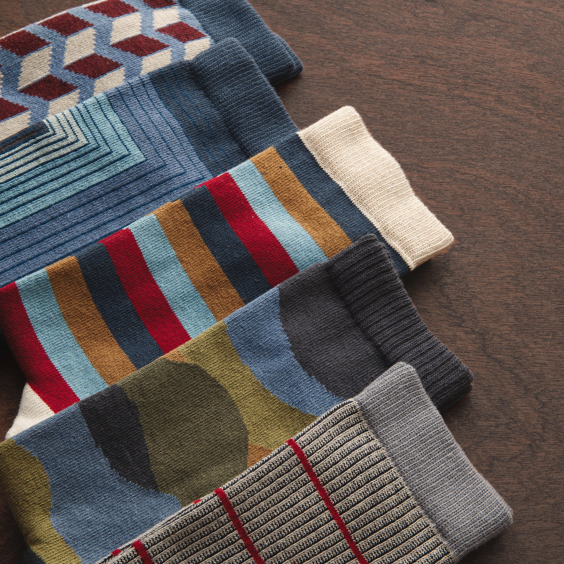 stripe patterned organic cotton socks laying on a wooden surface